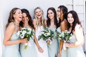 Wedding Photographer, five bridesmaids surropund the bride, all of them laughing and happy