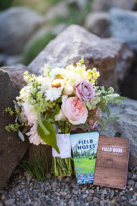 Adventure elopement vow books and bouquet